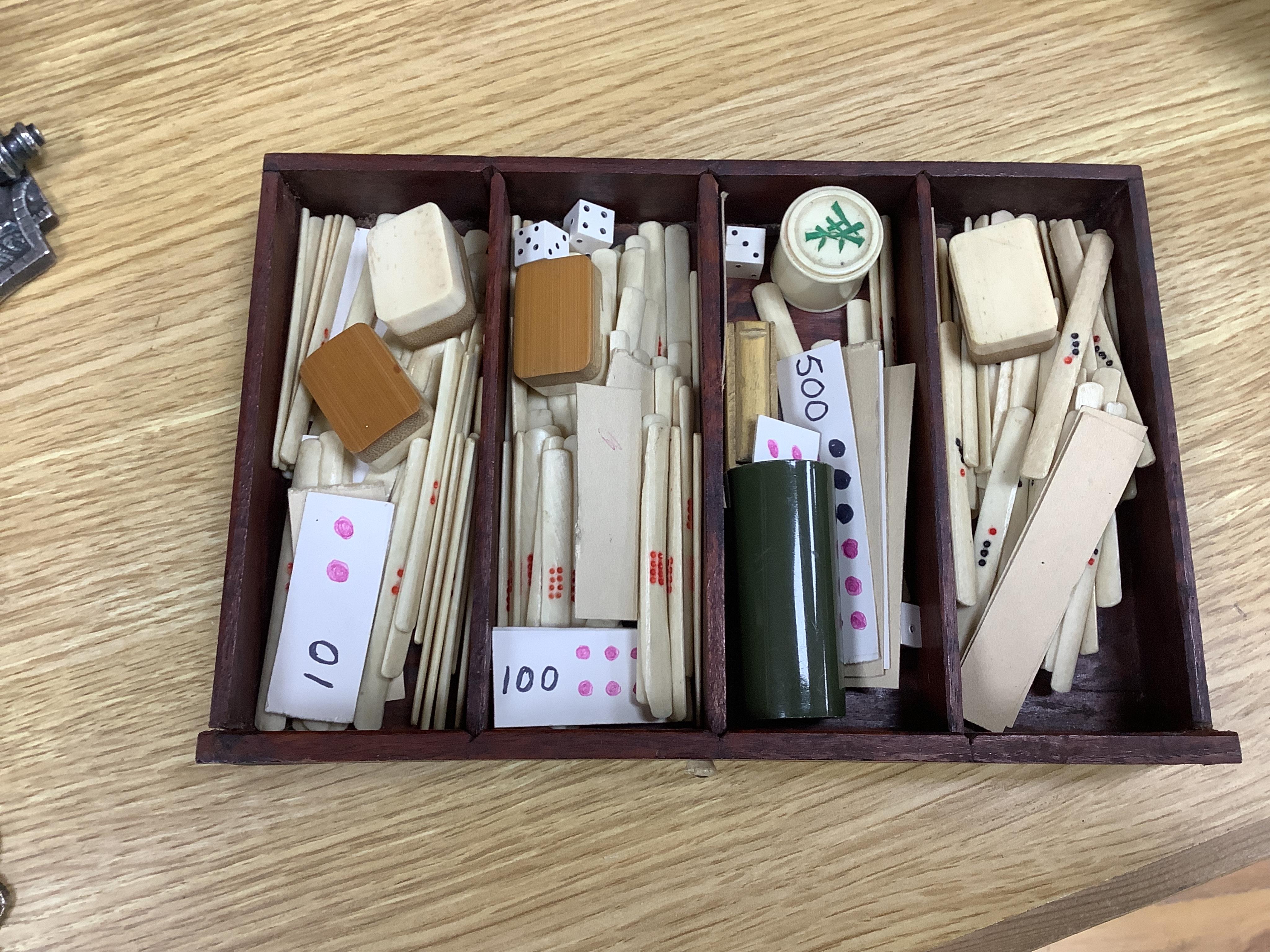 An early 20th century Chinese Mah Jong set, with bone tiles, 22cm x 15.5cm x 14.5cm. Condition - fair, one drawer front replaced